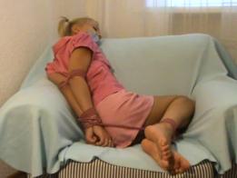 Phoxy in Pink Foxy has been captured and tied in a chair. She is wearing a pink outfit and is barefoot. Her situation doesn't allow much movement so she slowly accepts where she is. Found on kinbakublogger.blogspot.kr