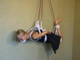Phoxy Phlying Foxy is suspended against the wall. She is in a hogtie and enjoys a tape gag. there is a lot of rope. Found on kinbakublogger.blogspot.kr