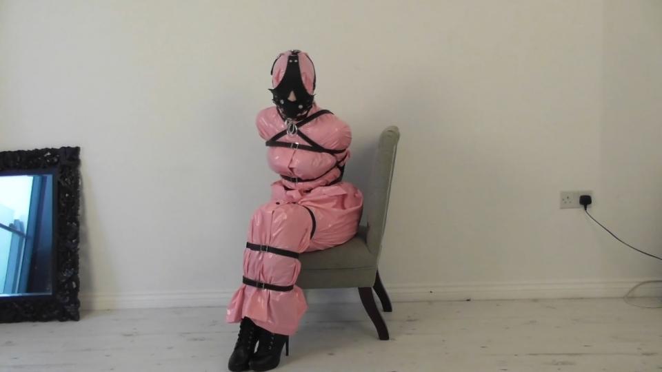 Jade, Imogen, Ruby in Leather Bound Strapped up and leather bound ladies combined with their macs and boots and you have a wonderful scenario that is always worth seeing on bondage loving beauties. A blue macked Jade has been strapped onto a high stool by a blue macked Helena and Jade has been gagged with a huge leather mouth filling gag. Helena removes this gag and fits a full head leather hood onto Jade and then leather bit gags her as well. Ropes from the sides of the hood now holds her back to the beam as the more helpless she is the better. Imogen has on a long green hooded mac and pink boots and after having her hands taped up inside the mac sleeves her arms are strapped together in front of her and then very tightly strapped to her body. Her leather gag is tied off overhead and then she is leather blindfolded as well. Then comes a leather head harness gag over the mac hood and then a large plug gag as she is laid onto the floor with her ankles strapped together as well. A variety of gags has to be a good thing. For Ruby it is a long pink hooded mac with high heeled leather boots and onto her goes a leather single arm glove and straps to bind her body. Around her neck goes a leather collar and onto her head goes a leather head harness gag with a large ball behind the face plate. Then after being sat onto the chair and more straps applied to her legs she was gagged with a huge leather gag filling her mouth and covering her face and eyes at the same time.<br><br>http://www.rainbound.com/home.htm<br>http://www.rainbound.com/payment1.htm<br>