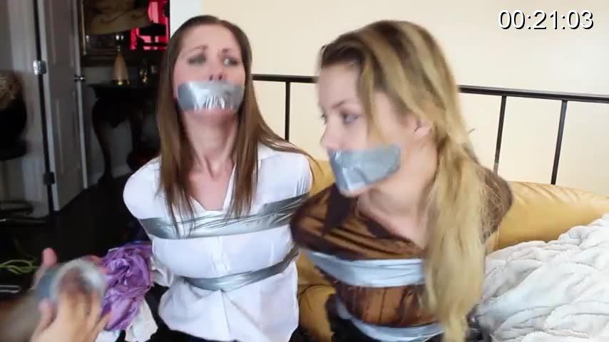 Businesswoman and her girlfriend tied and gagged during a home invasion Businesswoman and her girlfriend tied and gagged during a home invasion (Star. Charlize and Chrissy Marie)<br><br><br>Charlize is a sexy young businesswoman, chilling in her apartment when a burglar breaks in, Charlize is quickly overpowered and her hands are taped up behind her back. She tells the intruder than her girlfriend is going to get home very soon and she'll save her, but the bad guy doesn't take her serious and actually mocks her, telling Charlize that probably her girlfriend is some ugly fat chick, but Charlize tells her captor that actually her girlfriend is incredible sexy. The intruder finally gags Charlize with a strip of microfoam tape. After a couple of hours, Charlize's girlfriend finally gets home, and dam she's hot!!! A sexy brunette with a body and huge blue eyes, Chrissy Marie finds her girlfriend taped up and gagged on the floor and she thinks is some kind of role play game, so she grabs Charlize, sits her on a couch and touches her sexy legs while Charlize tries to warn her the intruder is still in the apartment. But it's too late before Chrissy realizes Charlize was not playing: the intruder grabs her and ties her up alongside her girlfriend, then Chrissy is also gagged with microfoam tape. The girls struggle in vain, they can't get free, but Chrissy seems to enjoy being tied up and gagged, while Charlize is so upset due to the humiliation of being in bondage. The bad guy returns and changes the gags of the girls this time to duct tape and leaves them struggling again. <br><br><br>purchase link : <br>https://www.clips4sale.com/studio/80159/18975877/Businesswoman and her girlfriend tied and gagged during a home invasion (Star. Charlize and Chrissy Marie) MP4 FORMAT