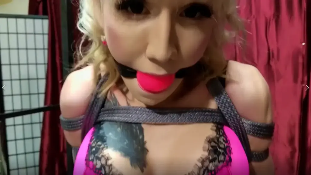 Lena Kelly.. Satin Captive Naughty blonde Tgirl Lena Kelly is constantly on her phone.. Always checking her social media and things.. and she has been warned several times to put it away, and now its time for a fitting punishment. She is ordered to dress up in silky pink lingerie, with stockings and satin panties on over the tope of her shiny pantyhose. She is dragged out to the dungeon to be tied up for the afternoon. Her arms are folded behind her, and heavy rope is wound around her torso and tits, enveloping her in a nice tight package she cannot escape from. A rope is tied around her waist and pulled down through her crotch and up through her ass and tied off, pressing her poor cock down and back, making it impossible for her to get hard. She is ordered onto the bed, where her tightly harnessed body is tied up and semi-suspended from the ceiling. Her legs are frogtied, and then tied spread apart to the sides of the bedframe, keeping her in a very helpless position. She glances up nervously.. A big pink rubber ball gag is added to keep her nice and quiet. Enjoy your afternoon Lena..<br><span style='color:#b0b0b0;'>[隐藏文字，购买后可见]</span>
