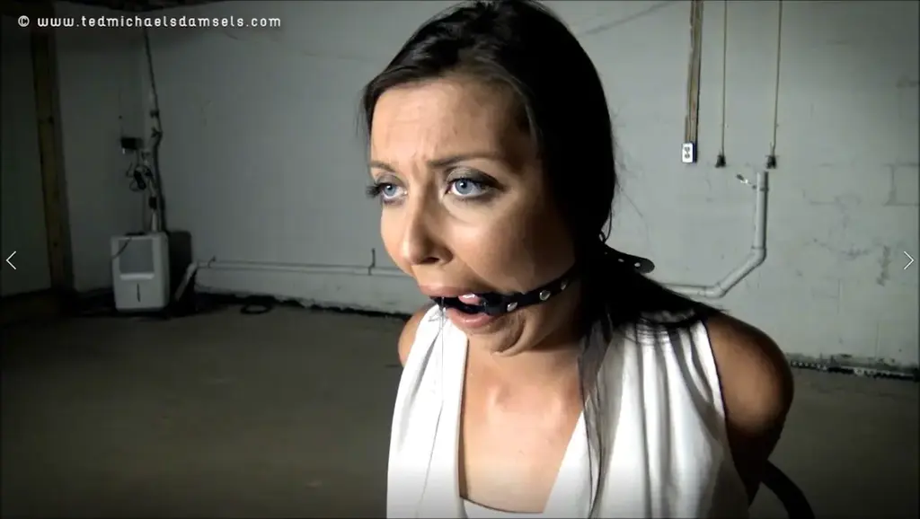 Maci Maci sits in a white blouse and blue skirt, her wrists already bound behind her back, while he straps a ring gag deeply into her mouth. She begins to drool almost immediately and drains like a faucet while he forces her knees apart showing black, lace panties. She whines when he sinks the crotchrope deeply into her cleft and grunts as it digs in even deeper when she again takes a seat. The drool keeps flowing while her ankles and knees are bound, and he leaves the gag in while he crushes her elbows behind her back. He ties a vibrator to her crotchrope, and she moans as the rope through her legs tugs against her. Finally she is given a break from the ring gag, and a massive amount of spit drains from her face and down her chin. Unfortunatley now he's packing a huge pair of purple panties into her mouth, slowly poking it deeper and deeper into her mouth and cheeks before wrapping duct tape around her face to keep it in place. With a flick the vibe it revs up to high sending vibrations through her. For six minutes she writhes in her bonds, moaning against the discomfort and the incessant stimulation from the tingling rope through her crotch. She fights the sensations at first but finds gyrating against the rope brings an ease to her torment. Slowly it builds until her face flushes, and she gives in to the sensation. He returns to shut off the vibe and removes her gag before freeing her arms. She is given a brief rest period while her removes her blouse and sorts some ropes. Soon she again feels her arms wrench behind her as thing rope cinches her elbows together once again. He ropes her ankles up to the ceiling, so she can do less to ease her discomfort before pulling down her bra and revealing her breasts. She opens wide to accept a sponge that with some effort he manages to stuff into her face. This time he uses microfoam to tightly tape her packing in place, and her eyes show the strain of this new test. He clamps each nipple with a clothespin and leaves her to struggle again. Luckily he left the vibrator turned off, so all she has to do is endure the clothepins and strict restraint. She moans into the sponge and wiggles as much as her precarious position allows. With her legs up and seated on a wobbly and creaking chair she doesn't want to thrash about too much. When he moves in for a closeup though, he turns on the vibrator and she shrieks as the tingling starts again. She struggles for long minutes, the stress of the position obvious on her face. Despite the constant buzzing inside of her the discomfort in her arms and nipples keeps her on the edge of release. With her ankles up she can't thrust against the crotchrope, so she remains frustrated and pained until he again returns. He releases her ankles and releases her arm restraint before having her remove her own gag. She is forced to leave the clothespins in place while she does, but she can't rush as the tape pulls at her hair while she works the gag away. He removes her bra completely this time and with the crotch rope still deeply secured and her ankles and knees still bound she barely has time to recover before he cinches her elbows together once again. She winces from the ache in her shoulders while he quickly binds her arms at the elbows and wrists. Again she opens wide for a huge pair of panties that are slowly stuffed inch by inch fully into her face before being brutally taped in place with clear tape. He brow furrows, her eyes show the stress and her cheeks bulge over the unnecessarily tight bands of tape. He moves her to the ground to suffer her fate on the filthy carpet and shrieks when the vibe is turned onto high. Her arms are on fire and her shoulders ache. Maci knows she cannot endure much longer, so she immediately starts thrusting her hips against the rope through her pussy. She grunts into her gag as first as the motions bring more discomfort but soon the vibration and released endorphines allow her to focus fully on the sensations she feels. As the minutes pass her groans turn into moans, her forced thrusts become times and sensual gyrations and her body glistens with the sweat of a building in side her bubbling towards release. Her breathing quickens and her moans come faster. She works her the rope faster and faster through her legs until finally her eyes flutter and roll back as she climaxes with the orgasm she hopes means her final release. But he does not free her, and the sensations continue to drive her hips. She is lost in the sensation and cannot stop as she moans writhes on the tail of her orgasm. She gyrated more, unable to stop her self and again her moans and breathing build. Faster and faster she moans, faster and faster she grinds her hips against the rope until again she cries into her gag with and even stronger orgasm. She moans, tenses and shutters in her bonds as she feels the release wash over her like many waves. She did her part. Surely now he'll let her go?<br><span style='color:#b0b0b0;'>[隐藏文字，购买后可见]</span>