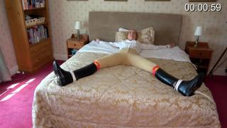 Spreadeagled &amp; Boots Pulled Off From: Ariel Anderssen Studio<br> <br>Description:<br><br>I wake up tied spreadeagled to a bed, but blessedly still fully clothed. Thank goodness! I'm not happy for long though, one of the wicked henchmen who brought me here returns, and starts untying one of my ankles. I soon lose hope that he's planning to set me free, though, because he immediately starts trying to pull,my boot off. This is the beginning of a mammoth struggle; the boots are tight and I'm in no mood to be cooperative! Sadly, in the end, he manages to succeed, whereupon he moves straight over to the other foot, with the same dastardly purpose! What a BEAST!! I'm glad I scolded him all the way through!
