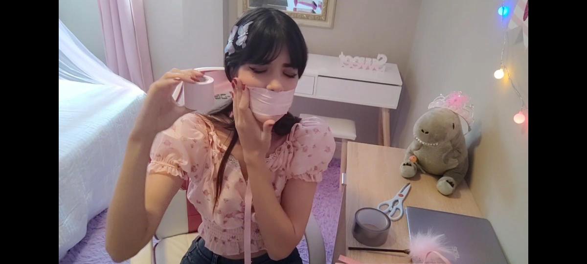Tape Bondage ASMR In the video I do a Tape gag ASMR, first I gag myself with a strip of pink bondage tape, then I do a wrap gag over my head after a few minutes I take of the pink tape and put two straps of silver tape over my mouth and stayed like that for a few minutes.