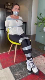 Brazillian girl taped to cahir Brallizan girl duct taped to a chair and wrap gagged.