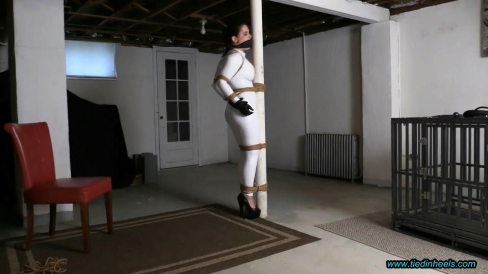 Tilly McReese Disciplined in The Basement Dungeon! sexy tilly mcreese gets captured and brought back to the basement dungeon for strict discipline! tilly's gorgeous body is encased in a skintight, white, pvc catsuit and she wears incredibly high, skyscraper high heeled, platform peeptoe high heels! this sexy lass needs to be disciplined in this sexy outfit! tilly is tightly roped up to the dungeon whipping post...the dungeon master uses unforgiving jute rope to keep her immobilized. a leather strap gag is buckled tightly over her mouth to keep her protests and whimpers to a minimum! after tilly is completely secured to the dungeon post her discipline whipping starts! tilly hates it and whines and struggles for her freedom! if this doesn't correct her behavior and get her to behave then  additional whipping sessions may be required!<br><span style='color:#b0b0b0;'>[隐藏文字，购买后可见]</span>