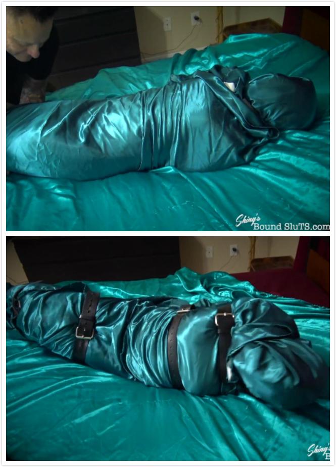 Wrapped and Strapped 性感的T-女孩罗克西心屈服于缎子包裹木乃伊束缚。她只穿了一条热粉色的缎子内裤，手腕和脚踝都用绳子绑着，嘴里还绑着一个大大的粉色球塞。接下来，她被卷成一块像玉米煎饼一样的缎子，然后用厚皮带紧紧地绑在一起。缎子，当它是厚厚的分层，可以是非常无情的，因为罗茜发现！她在光滑的绸缎床上扭动着身子，试图逃走。在被包围了好几分钟后，她承认失败，并要求被释放。Sexy T-girl Roxi Heart submits to a satin encasement mummification bondage. Dressed only in hot pink satin panties, her wrists and ankles are bound with rope and a big pink ball gag is strapped into her mouth. Next she is rolled all up in a satin sheet like a burrito and then strapped up tight with thick leather belts to hold it all together. Satin, when it is thickly layered, can be very unforgiving, as Roxi finds out! She squirms and wiggles on the slippery satin bed trying her best to escape. After several long minutes encased, she admits defeat and has to ask to be released.<span style='color:#b0b0b0;'>[隐藏文字，购买后可见]</span>