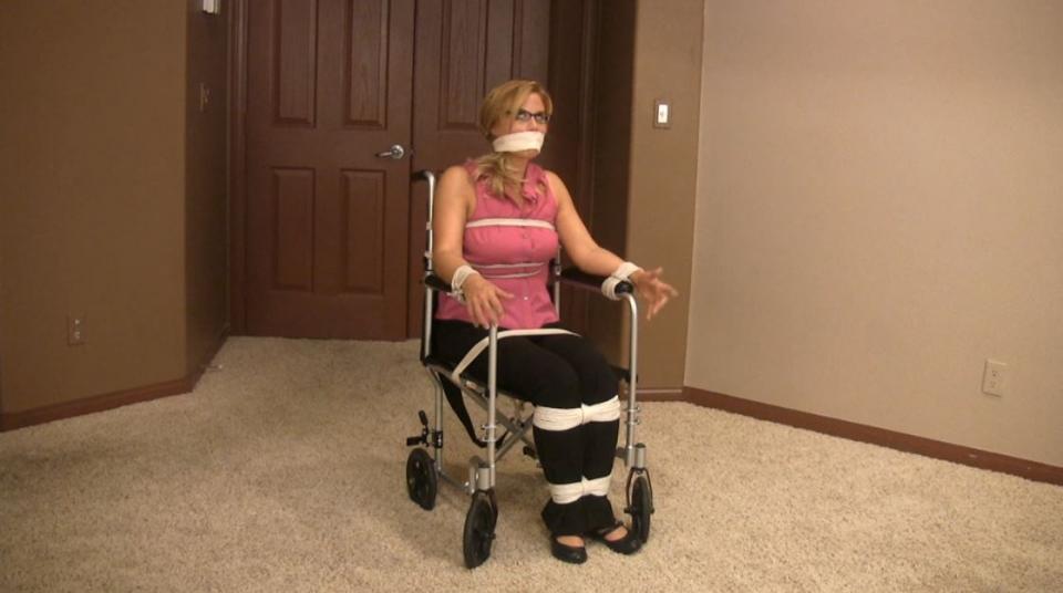 IS-BW00111 - Unsympathetic Wife IS-BW00111 - Unsympathetic Wife. Katherine West is trying to rush off to work, but her husband is in a cast and confined to a wheelchair and he asks her first for his books, them his glasses ... and she's running later and later. She complains that he is milking his situation, and that he should be more than capable of taking at least basic care of himself. He apparantly DOES have enough mobility to get out of the chair onto his crutches and manages to nestle his pretty blonde wife into the chair - but he ties her in place (and gags her too, so he doesn't have to listen to her complaints) and challenges her to try to get herself around the house!<span style='color:#b0b0b0;'>[隐藏文字，购买后可见]</span>