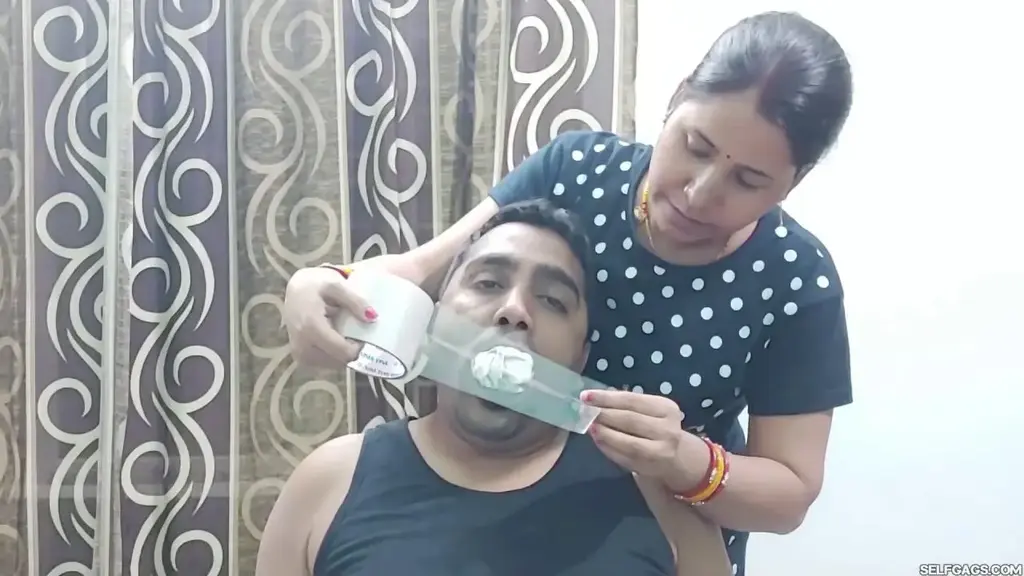Don't Mess With A Pregnant Indian Woman! Title: Don't Mess With A Pregnant Indian Woman!<br><br>Description: Indian pregnant wife Kiraneya has a husband with a very foul mouth and she doesn't like it. What she does like is to shut him up and teach him a lesson from time to time!<br><br>Kiraneya handgags her chair-bound husband and starts to play with his mouth by squeezing, pulling, and stretching it. The sexy wife thoroughly packs a whole hanky inside each of her husband's cheeks to create an incredible and effective full mouth stuffing which she seals in with clear transparent packaging tape wrapped around his head!<br><br>The tight tape wrap gag keeping the mouth packed hanky in place is then fully covered up with a turquoise patterned scarf which Kiraneya ties over her husband's tape gagged mouth like a tight over-the-mouth gag! Kiraneya demonstratively sits down next to her bound and multi-gagged husband and pretends to be wanting to understand his muffled words.<br><br>Kiraneya hits her husband's massive gag when she thinks he is being too loud but the hanky mouth stuffing, the tape wrapping, and the over-the-mouth gag don't seem to be enough for the pregnant wife who grabs another scarf and completely encases her husband's head really tight with it!<br><br>Included in this clip: femdom bondage, hand over mouth, Indian, hanky mouth stuffing, tape wrap gagged, female domination, gag talk, muffled noises, men in bondage, femdom, humiliation, domination, head encasement, OTM gagged, pregnant, scarf fetish, multilayered gagging, BDSM, gag fetish<br><br>Clip is 11 minutes and 11 seconds long - 1920x1080<br><br><span style='color:#b0b0b0;'>[隐藏文字，购买后可见]</span>