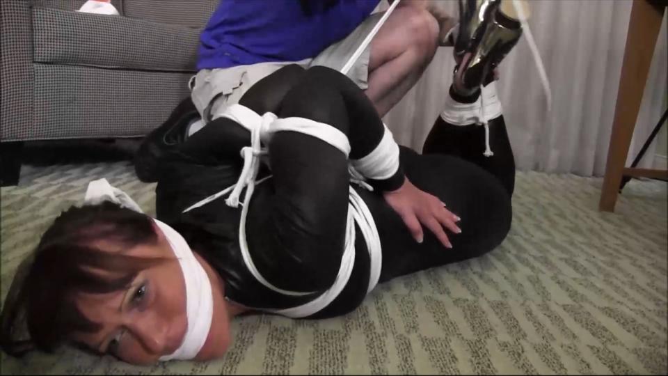 OSB2106-Captured Cat Burglar elbow tied and gagged tight Yvette was sent to his room to steal some top secret files. But all of a sudden, she heard him walk in and had to quickly hide. But somehow Yvette made some noise and he heard her. When he grabbed her, Yvette put up a fight. He used the hotel phone to call for the authorities. But being in a foreign country, no one could understand him. Yvette also, only spoke German and he could not understand a word she was saying. The man had no choice but to tie her up and take matters into his own hands. As he tied her tight and with lots of rope, Yvette continued to shout at him in German. So once he had her all trussed up, he shoved a gag in her mouth and tied a rag between her teeth to shut her up. Yvette still refused to stay still as the man again tried to call the hotel desk for help.. But because he still could not find anyone that spoke his language, he again had to hang up so he could deal with Yvette. This time, he made sure, she was totally helpless. He tied her in a very strict hogtie with her hands pulled way up her back. Although Yvette could not understand him, she what was going to happen and she squealed loud through the gag as he started undressing her. All she could do was hiss and glare at him as she knew now that she was at this foreigner's mercy.<br><span style='color:#b0b0b0;'>[隐藏文字，购买后可见]</span>