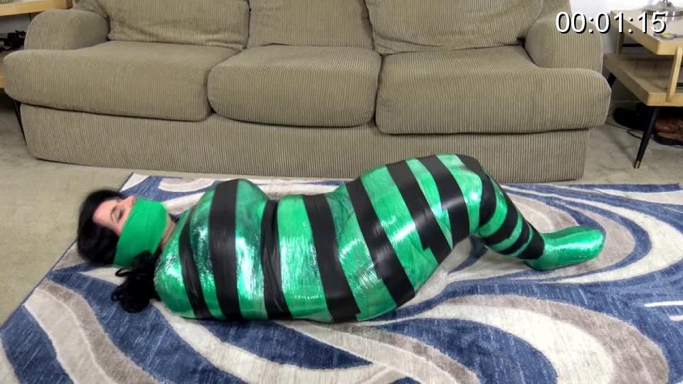 297 - Bettie's First Mummification Poor Bettie Buxome! Her refusal to reveal corporate secrets to the industrial spy has really gotten her into a tight spot now! She’s been tightly wrapped in countless layers of plastic and tape and is forced to squirm around like a worm in an effort to get loose! No one can hear her through the layers of adhesive wrap sealing her pretty mouth shut, so she’s completely at the mercy of the nefarious fiends who have turned her into a pathetic package! Every inch and curve of her voluptuous figure is highlighted by and trapped in the stifling cocoon: even her dainty little feet are completely sealed within the confining cocoon! As she rolls around in an effort to escape, she knows she has to act fast lest the creep return to finish her off for good, but with her limbs fused together in her plastic sheath, how can she possible make her way to freedom??<span style='color:#b0b0b0;'>[隐藏文字，购买后可见]</span>