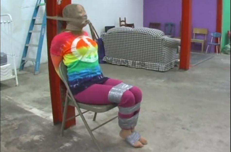 Mina Bound with Tape and Hooded Mina Bound with Tape and Hooded. Sexy Mina gets bound with duct tape wearing a cute and confy outfit consisting of pantyhose, pink pants, bright yellow pumps, and a tie-dyed peace t-shirt. She's gets roped into this situation by Stacy who tells her it's just a game but once her wrists are taped up behind her back and she gets her mouth stuffed and sealed shut with duct tape, she knows that she's in for more than she bargained for. Stacy takes off her high heels and taped her feet together and tapes her thighs together too. She's kinda freaking out at this point but wait until you see the pantyhose gets pulled over her head!<span style='color:#b0b0b0;'>[隐藏文字，购买后可见]</span>