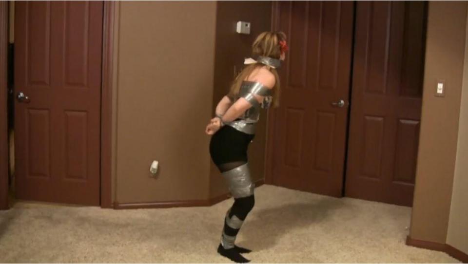 IS-BW00084 - Duct Taped to Stay IS-BW00084 - Duct Taped to Stay. Mary Lou is dragged into the scene, partially duct taped and full of fight. Wearing cute black shorts and black tights, her sassy attitude gets her quickly gagged with a cleave gag and a full wrapped-around-the-head duct tape gag. The tape over her hair really makes her angry, and vigorous struggling and an unsuccessful escape attempt ensue. She is rewarded for her escape attempt by being duct taped to a chair so much she is nearly mummified.<span style='color:#b0b0b0;'>[隐藏文字，购买后可见]</span>