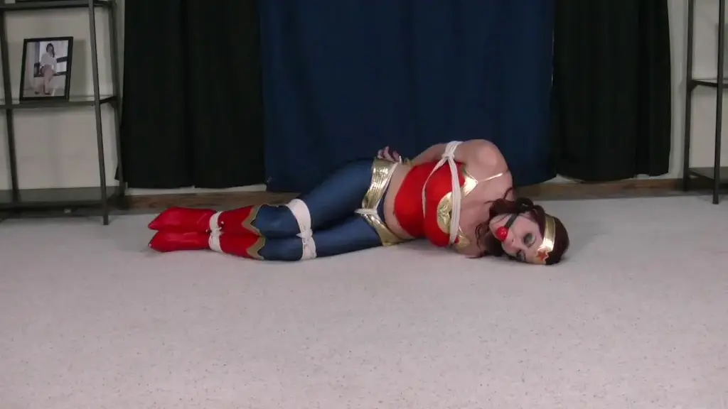 Sarah Wonder Woman to the Rescue Wonder Woman Sarah has come to look for her partner Spider Woman just as I expected. Sarah arrives in the same room looking for the same chest and Sarah is as eaisly captured as her partner was. Sarah slowly wakes up to find herself very tightly bound and gagged. Sarah fights and struggles but makes no progress against the rops and gag. With her partner already captured there is no one to save Sarah now, she needs to figure out how to get out of this on her own!<br><br><span style='color:#b0b0b0;'>[隐藏文字，购买后可见]</span>