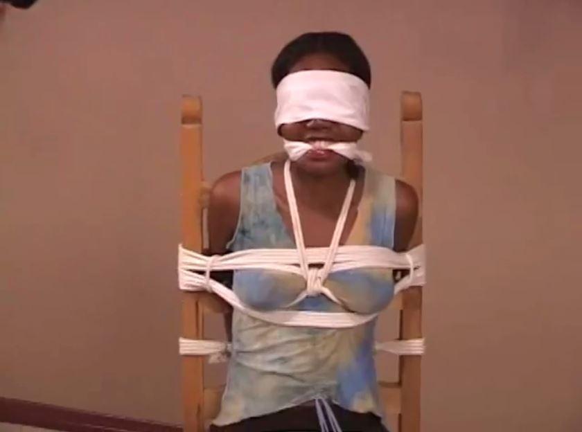 Nina Devon BTS (2) Nina Devon BTS (2). Nina is tied to a chair wearing a tank top , cleeavegagged and blindfolded. <span style='color:#b0b0b0;'>[隐藏文字，购买后可见]</span>