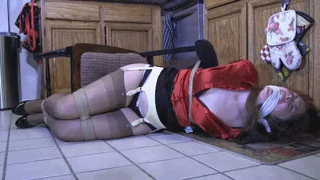 2108RACHEL-Home Invaded and tied down to a chair Someone has come into Rachel's home. He has her blindfolded and tied down to a chair.  When Rachel starts making too much noise, the man stuffs her mouth and ties a rag between her teeth gag her. Rachel is left to struggle on the chair.  Some how she gets the blindfold off.  But she cannot not get herself untied. Later, she has struggled so hard, the chair has fallen over.  Now on the floor, all Rachel can do is wait for someone to rescue her. Suddenly, she hears a knock at the door.  She screams through the gag, but no one can hear her. Hopefully the person knocking will go around to the back down and find it left open by the bad guy when he made his escape. <br><br><span style='color:#b0b0b0;'>[隐藏文字，购买后可见]</span>