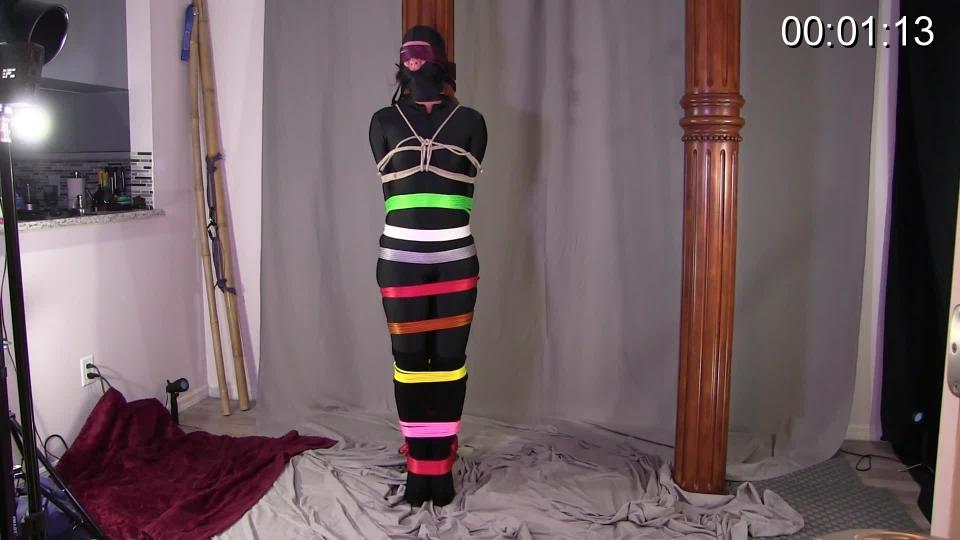 Escaping the Cursed Catsuit Rainbow Bind This catsuit of mine must be cursed since whenever I wear it, whomever is around me must tie me up. Its a helpless irresistible urge that cant be helped. Who am I to stop this from happening. The problem is, they have no urge to untie me so I must get out on my own or try my hardest. You get a good look at all the colorful ropes wrapped around my body as I am standing upright against a wooden pillar. My eyes are covered in rope, my mouth is gagged with rope and a couple hundred feet keep my from moving much at all. I wiggle and writhe as I test the ropes. I must be patient and safe as I slowly but surely wiggle my hands free. If I can get this blindfold off and my neck rope off, I then can safely work on loosening the other ropes. I work my way down as this is not an easy task as Knotty Guy really tied me tightly. I work on each different color rope as they fall down on catsuit clad body and over my thigh high, high heel boots. Luckily I manage to escape but just in time for him to return unable to resist the urge to threaten me with more rope and more bondage.<br><br><span style='color:#b0b0b0;'>[隐藏文字，购买后可见]</span>