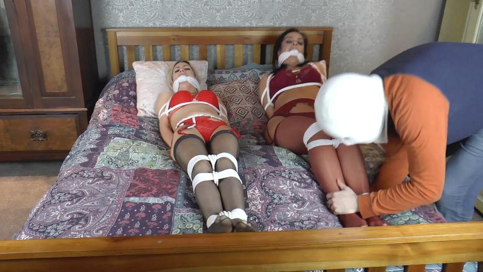 Ellie &amp; Latina in Routinely Resisting Lingerie Models Need More Ropes &amp; Gaggings to Keep The Ellie & Latina in Routinely Resisting Lingerie Models Need More Ropes & Gaggings to Keep Their Struggling Asses in Check! (HD)<br><br>Catching them in with the telephone and furiously ripping it from the wall, Masked Intruder #2 winds up the cord and stalks off – but not before the insolent girls, all tied up on the bed, have been gagged again, most harshly, with thick knotted rags. They’ve also been trussed to the bed-frame, to teach them a lesson in staying put and not trying to cause a problem! The babes glare at him, jaws wedged wide, mouths filled completely The fiends! What are they planning next?