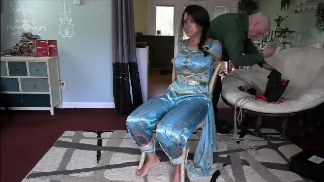 The Princess Delusion (MP4) - Jasmine St James In his absence, Jasmine struggles desperately to get free before he comes back. The man is clearly off his meds and needs help, but Jasmine does not want to be the one to deal with it. Unfortunately, she can't free herself before he returns, and can't stop him marching her, with hands still bound and gag still in her mouth, to his vehicle. He takes her to his house and to a bedroom where he has already set up handcuffs and shackles, and tells her this is her palace. Trying to play into the old asshole's delusion, she says that she is actually a princess after all and demands that he follow her instructions to let her go. Because the old man thinks she is the one who is deluded, he refuses to obey her and cuffs her to the bed. He wants her to rest, and to keep her quiet while she calms down, he gags her with duct tape.<br><br>