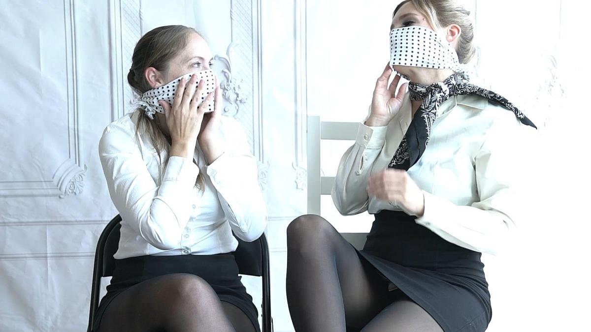 Rachel Adams &amp; Blair Blouson Gag Interview Rachel and Blair are two popular bondage models in the industry. One day they had the chance to catch up to chat about gags of all sorts.<br>1) They start with white cleave gag with polka dots (known as Japanese Mameshibori gags). They try out OTM and OTN styles and discuss their effectiveness.<br>2) Next they switch to Bishop panel gags. One has the buckle and straps version, the other has the button version. Watch them exchange opinions of their styles.<br>3) Next they switch to harness ball gags. They both have the red ball but one is larger. They, of course, try to do some gag talking.<br>4) Next they switch to panel gags harness style. The two gags are almost identical in shape, just the leather is different. Watch how they discuss the nuances between them.<br>5) Next they try out microfoam gags. They do the wrap-around-head OTM gag. Watch how they gag talk and mind the lip print when they take off the gag.<br>6) Now they switch to hard-core trainer-style gags. Rachel gets our most popular gag: the open mouth plug gag (bought from Japan), and Blair gets the full head harness panel gag (panel gag plus head straps). Watch them check out each other with our ultimate gags.<br>7) Finally, they try on a new gag: the penis connecting gag. It's basically a double-sided penis gag that bonds two damsels together. Quite an interesting gag to try-on as they say!