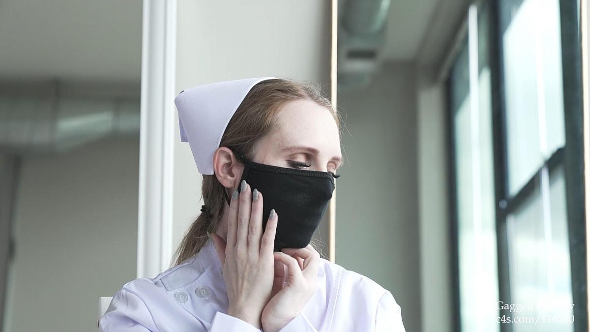 Vivian Rose Mask Fetish—Nurse Uniform Vivian Rose is a strict nurse at some medical facility. She starts work by donning a cotton tie-back medical mask and latex surgical gloves. How do I look? Next, she changes the masks to figure out which one looks best. A white stretchy cotton masks is shown, followed by pink, tan, and black. Next, she makes an OTM bite-down gag from a cloth to prevent her from chit-chatting on the job. Finally, she applies an OTN gag using a piece of cloth to make it more like a mask than a gag. At the end, some quick outtakes are shown. Definitely don’t miss this gorgeous work of mask fetish!
