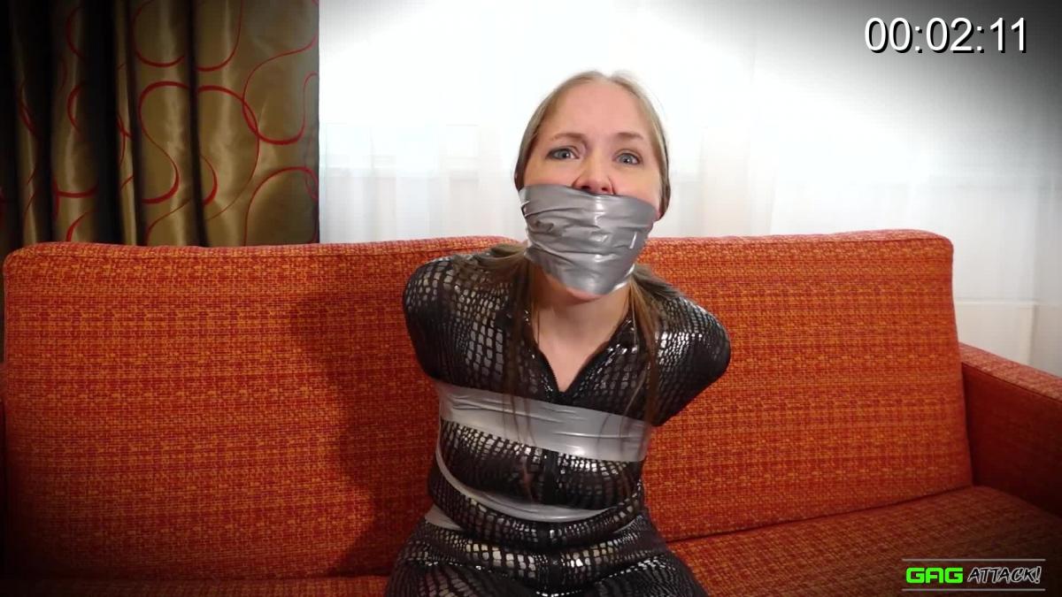 Rachel Adams - Catsuit Burglar Taped Rachel is a captured catburglar she is tied heavily with duct tape. When her captor enters the room he starts immediately with stuffing her mouth with a black sponge and tightly wraps around duct tape as a wrap around gag. He leaves Rachel alone to struggle and she does that as much as she can in her tape bondage. She looks around while MMMMMPPPPPHING giving you a good side profile view on the tightly...