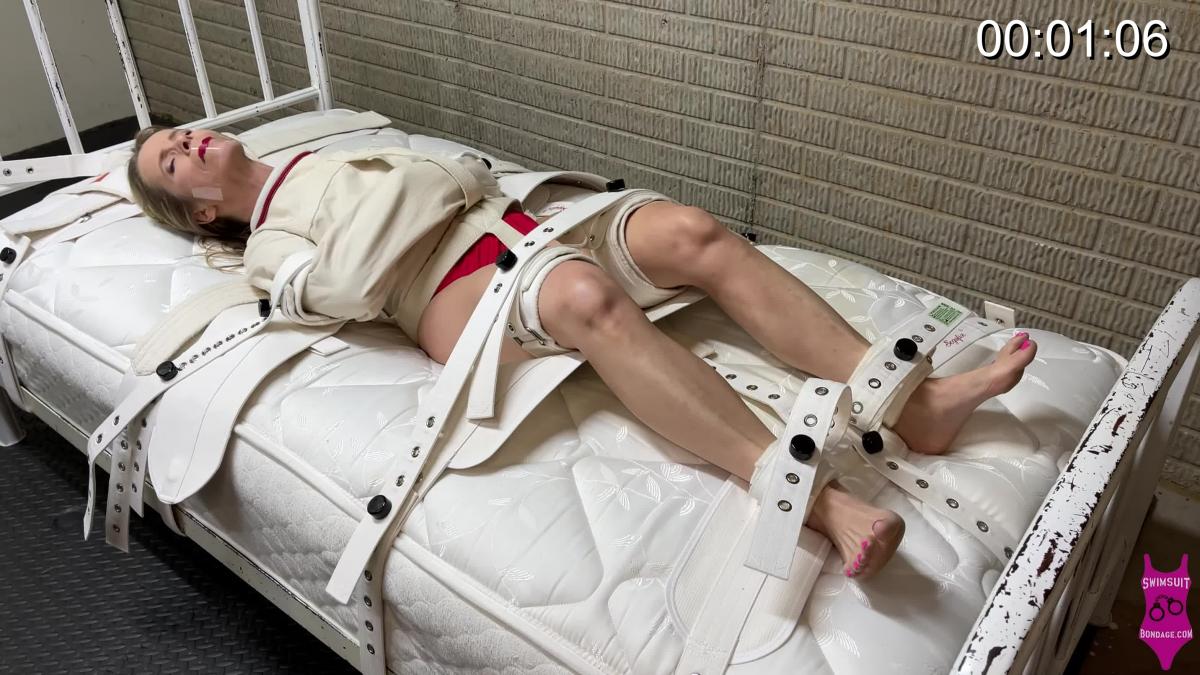 372 Clair Segufix Claire is wearing red bikini and is in a Posey straight jacket she is also strapped down to the bed with Segufix medical restraints. She is gagged with clear packing tape. Watch are she struggles to free herself