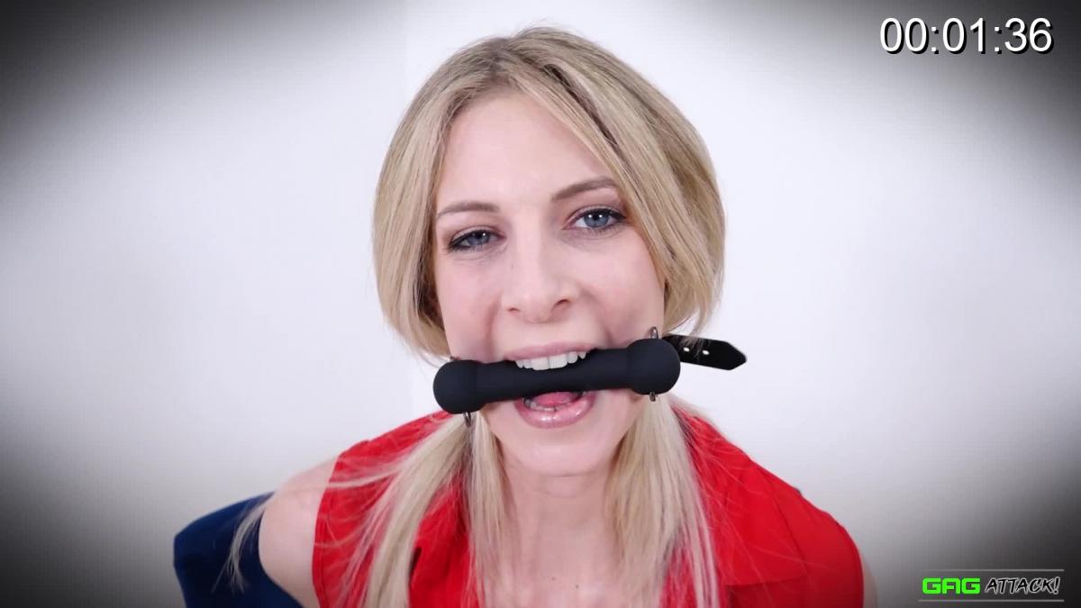 Rebecca Leah - Various Gag Devices She has great fun being repeatedly gagged - Rebecca is keen for more!<br> <br>Blue-eyed blonde beauty Rebecca is bound in a chair, wearing black lingerie under an open red shirt, and welcomes the prospect of being gagged, too. She starts by having a bit-gag strapped between her lips, and struggles playfully, showing off her lovely long neck and bare shoulders. She gag-talks indistinctly and drools a bit.<br> <br>Next having her mouth stuffed and ring-gagged, Rebecca's drooling stops, but she is quieter. She wiggles about, but clearly doesn't mind being bound and gagged, making no serious attempt to escape. When the gag comes out, she thanks her captor!<br> <br>Finally, a bright red ball-gag is pushed between her teeth. Rebecca's eyes smile, even if her mouth can't, and when ungagged, she says she's had 'so much fun'. Us too, Ms Leah - how about some more gags?