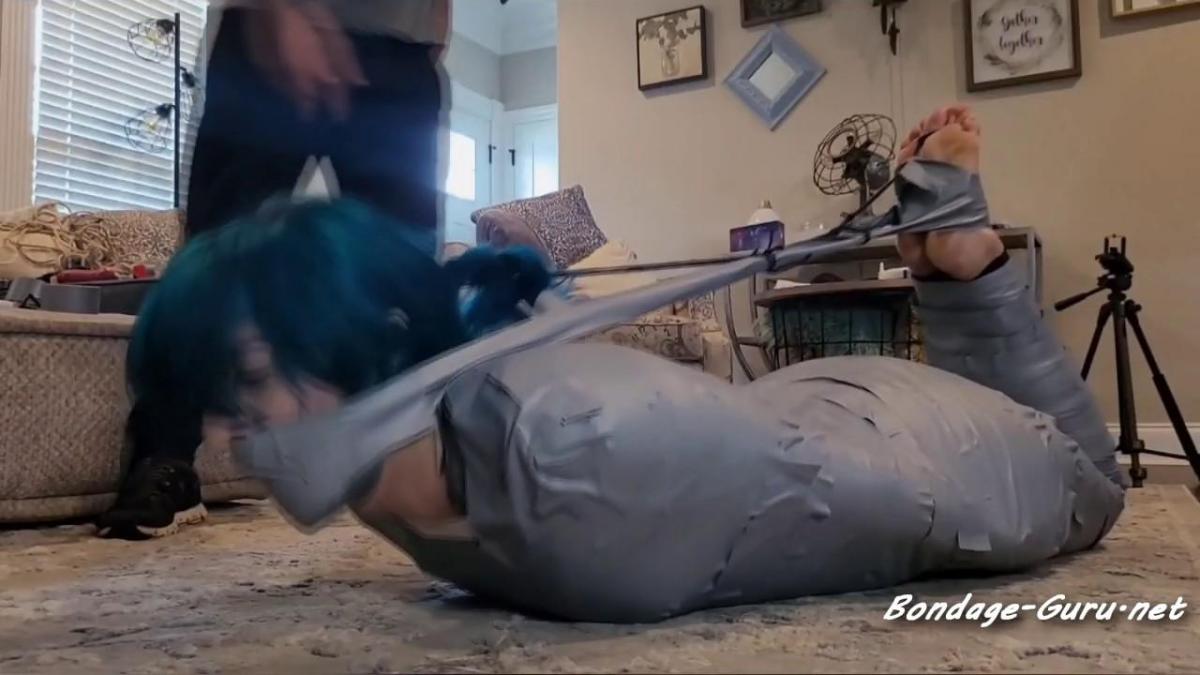 Mummy Mia! Wrapped up in silver tape, shoulder to ankle, Mia Hope struggles on her belly on the floor. Her flip flops are pulled off, and she is well gagged with a mouth packing and wrapping. Her big toes are bound next. More struggling and moaning. If continues to escalate, with her gag being layered again to her feet, which have now been wrapped up also, leaving her heels and toes visible and wiggling. Mia fights and fights to no avail. No escape 