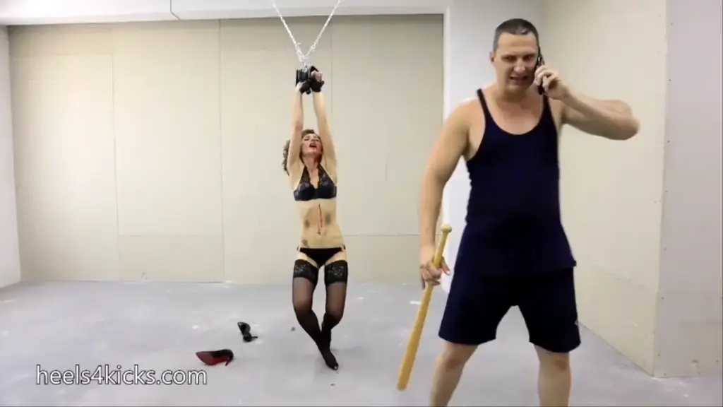 Unbreakable agent Rhea has saved the disk. Part I our superheroine Rhea is tied her hands are over her head (she wears a white shirt, black skirt, black stockings and high heels). She slowly wakes up, a man with a bat is in front of her. 
