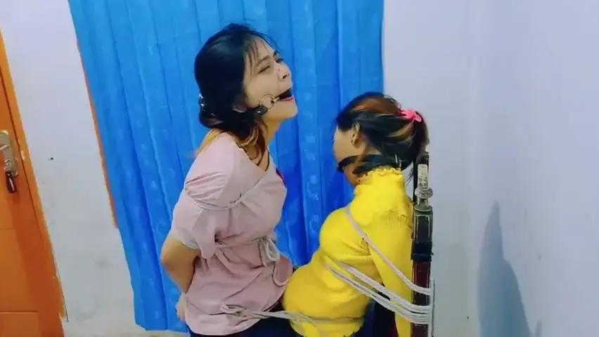 2 Indonesian Girls Tied Up On 1 Chair Together (ID-BOUND032) 2 Indonesian Girls Tied On 1 Chair Together In Bedroom