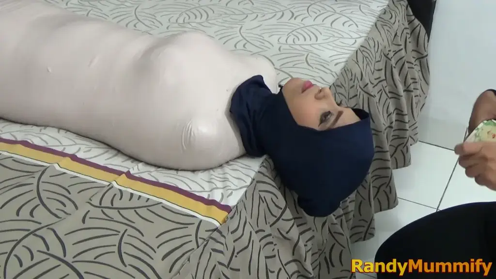 [RM116] Beautiful Girl of Pakistani Descent Wrapped Into A Living Mummy Until Helpless A Pakistani girl mummified for the first time.<br>The girl's body was tightly wrapped with white duct tape and left the head uncovered until the final scene was completely wrapped.