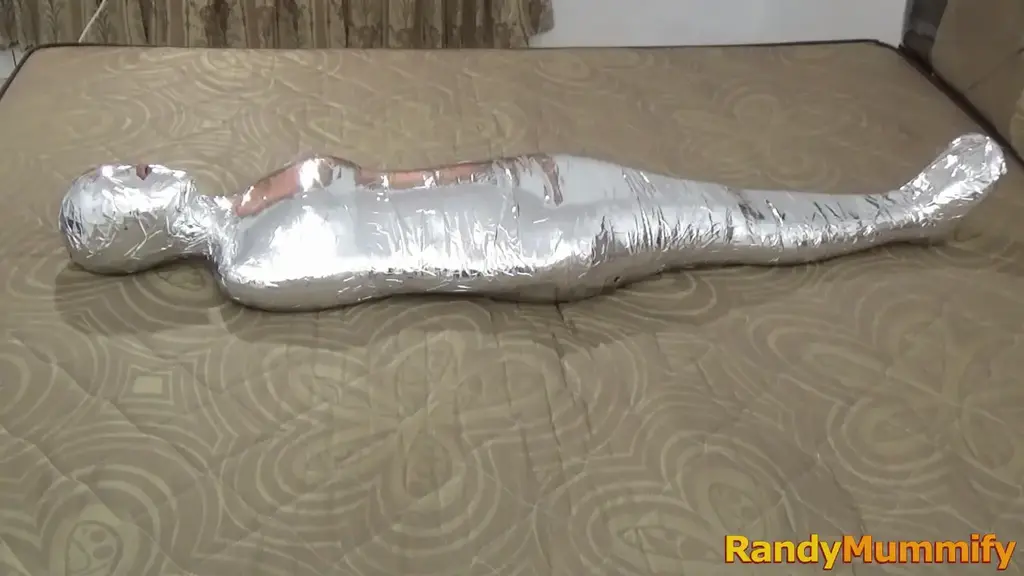 [RM119] A beautiful girl 150 cm tall the mummification with 2 layers of duct tape A beautiful girl with a height of only 150 cm wrapped mummified alive for the first time.<br>This is the first time she has become a living mummy, this girl has been wrapped in 2 layers of jet duct tape so that her body is easily lifted.