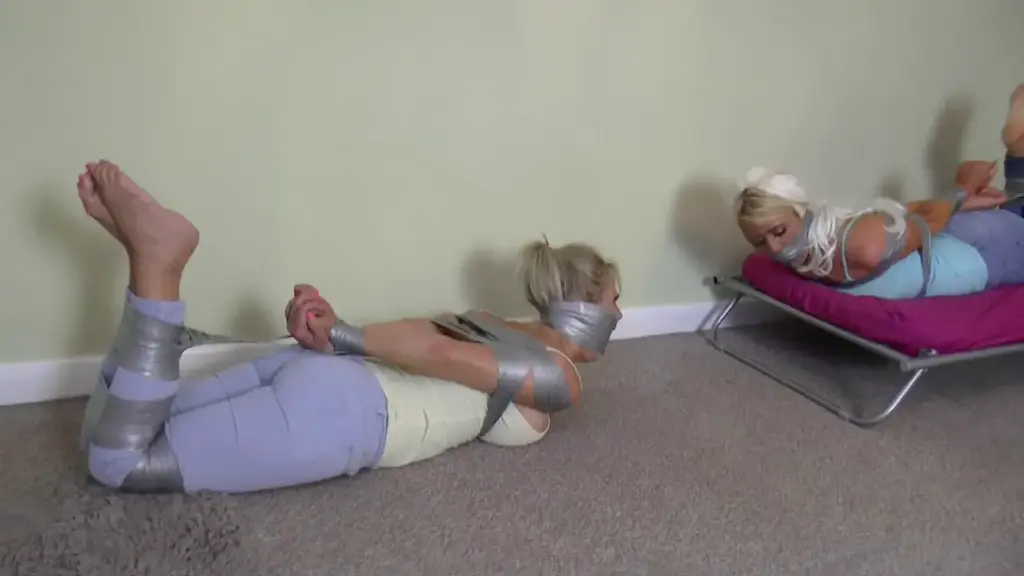 Brooke &amp; Lacey in: Tightly Trussed, Double Sock Plugged n Monster Muzzled Girl Detective Wriggle Complete title:<br><br>Brooke & Lacey in: Tightly Trussed, Double Sock Plugged n Monster Muzzled Girl Detective Wrigglers! (Full Adventure) (HD)<br><br><br>Ah, to cram those pairs of socks into those gorgeous, feisty mouths hard and definite enough to bulge their cheeks like hammyhamsters and bundle their lower faces up, mummy style! Tis the only way to deal with such meddlesome little detective brats, we fear. Would you not say?<br><br><br>The girls, ultrahot and reliable damsel Brooke and her scorching newest babe pairer upper, Lacey, have been drawn to a spooky old place out in the woods where it is believed dark rituals are performed under cover of that black stuff in the sky. They don't like this case. The house is too silent, too eerie. They feel, not alone, even though intelligence back at HQ had advised otherwise in this mornings brief. Hearing one measured tread to the floorboards too many arouses Brooke (not literally, that's for us lot) and her attentions, so she heads off to investigate, leaving lovely tight jeans clad and canvas pumped up Lacey alone in this creepy room. Having a snoop about downstairs (well, its what they do intit?), suddenly Brooke is pounced upon, wrapped in a hard hand gag and hustled back to the room where Lacey is ordered to get her hands up while her big titted partner squirms and mmmmmppppphhhhs. Then both surrendered detectives are bound at the wrists and tape gagged with multiple strips of white duct slapped over their sexy kissers. Left gagged and bound, their fate possibly more than a little related to some latterly transpiring magic ritual, the immobilised blondes struggle furiously, gag talking with typical Borderland Bound style hotness. Then both are revisited, caught trying to free one another, and PUNISHED!<br><br><br>Both canvas pumps and both socks are whipped off both sets of nice, sweaty feet and its double sock mouthward thrustings ahoy. The girls resist as much as they can having their mouths well and truly packed. Then both are savagely tape bound up about the face and left to struggle and strain merrily away again.<br><br><br>Intrepid Lacey manages to get her sexy rump down alongside a muchly gag effusing Brooke and both wriggle and roll around, quite deliciously we must observe, all over the floor. Trying hard to free themselves and desperately, hugely muffledly, trying to communicate their frantic concerns while about it. When the Keeper of the House returns, he spanks, fondles and binds the pair further as they wiggle and squiggle against him, into meaty tape hogties. Facing one another throughout, both massively gagged babes try valiantly to talk, thumping up and down on their lush tits and thrusting those highly edible sit upons skyward at every available, tape pulling opportunity. This one is sexier than a bag of, uh, sexy gagged up women (all we could think of, funnily enough) as these two incredible, full throttle style performers go through this giant tape hogtying extravaganza with true feistiness and determination, all trouser twitchingly barefoot and toe pointing, mmmmmmpppphhhhhhing and twisting for your abject entertainment. Its just HOT, dudes, yeah? Simple as. Snap it up quick. Youll thanks us for it in the morning!