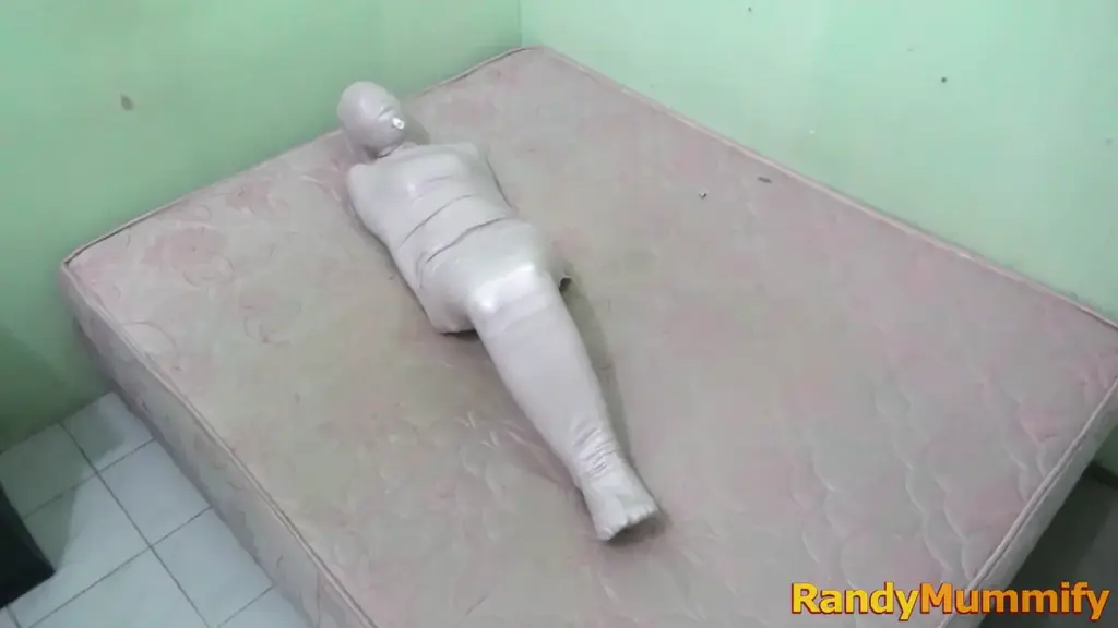 [RM087] The first girl to be mummified was just breathing from a small tube A beautiful girl wearing an orange swimsuit when wrapped for the first time becomes a mummy.<br>The girls body was wrapped tightly using white duct tape and this girl only bought an airway from a small tube that was inserted into her mouth.