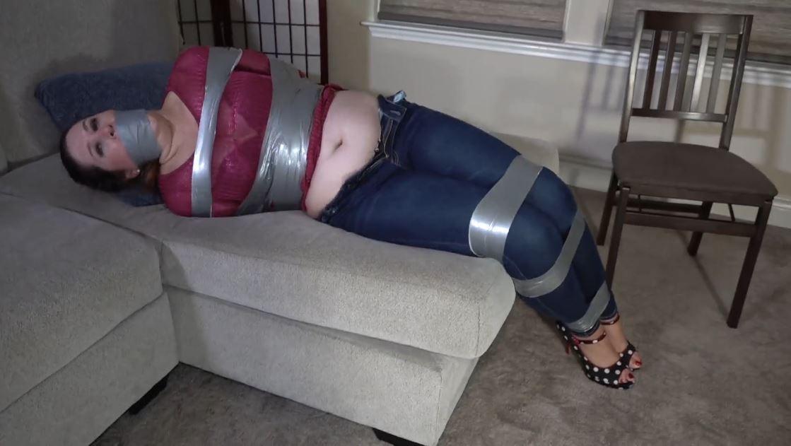 2212LOUISE-Housewife taped up in her living room Louise was home when this man came into her house. She had a lot to do before her husband came home later in the evening. But that would have to be put on hold for another dat when the man tapes her up tight and gags her.