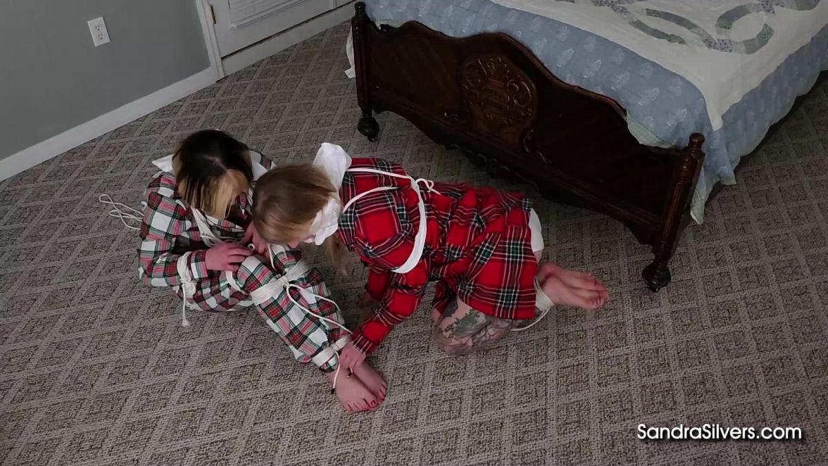 2966 Sandra Silvers, Lexi Lane &amp; Catherine Sterling Christmas Vacation at a B&B turns Bondage Time Out for Lexi Lane & Catherine Sterling – Tied Up in their Pajamas by satin Night Gowned Landlady Sandra Silvers! Part 1 of 2 of a Custom Video<br><br>Finding their B&B box spring mattress to be super soft, Lexi and Catherine can’t help but bounce up and down on the squeaking bed frame, which soon turns into a noisy tickle-fest between the giggling girls in plaid pajamas. The noise must ring through the walls of the Bed & Breakfast they are staying in this Christmas Eve, as the Landlady soon comes bursting through the door! Seems MILF in satin nightgown Sandra Silvers is used to dealing with such troublesome guests at her hotel establishment, as a stash of rope is handily in the nightstand alongside pillowcases for thick cotton cleave gags each. The stern mistress of the boarding house ties up the naughty twosome - Lexi classically tied on the bedcovers and Catherine in a hogtie on the floor - and leaves the barefoot pair to struggle in silence as she switches out the light! These two wriggly customers have a mind to escape, and secure revenge…