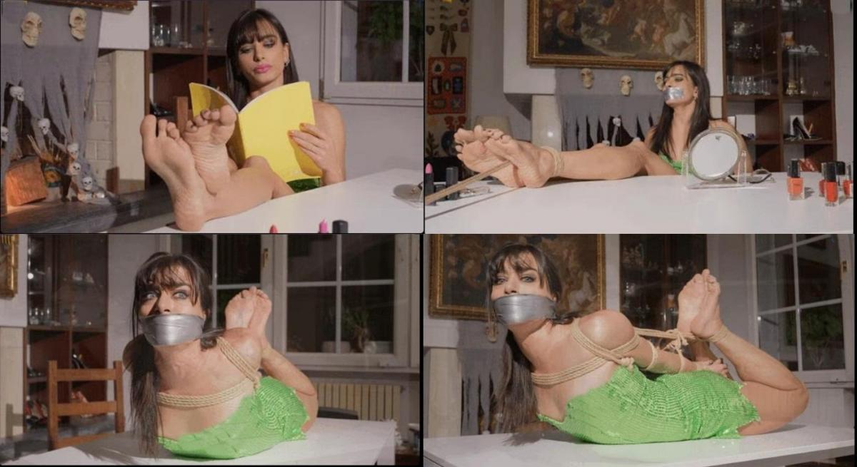 Lara - Sensual lipstick (ultraHD) Lara is testing her new lipsticks and lipliners for her night at the disco when an intruder takes her by surprise and shows her his plan for the night are definitely different. He hand gags her with his gloved hands before gagging her with pvc tape. Poor Lare is bound with her hands behind her back and her feet on the tables, big toes tied. The intruder leave her alone to runsack her house. He is not aware that Lara has a liner right below the notebook that is on the table. Not that is going to be easy for our heroine to get it of some use with her feet tied like this, but she has to try at least. But she is not fast enough as the intruder is back all over her to remove her gag for some interrogation, he wants the combination for the safe upstairs and is going to leave only when he get that information. Now satisfided he prepares Lara for the night. He stuff her mouth and seal it with wraparound pvc tapegag and proceed to place her in a very tight hogtie. He wants to be sure that he has enough time to be all out of the way before Lara can call for some help<br><br>