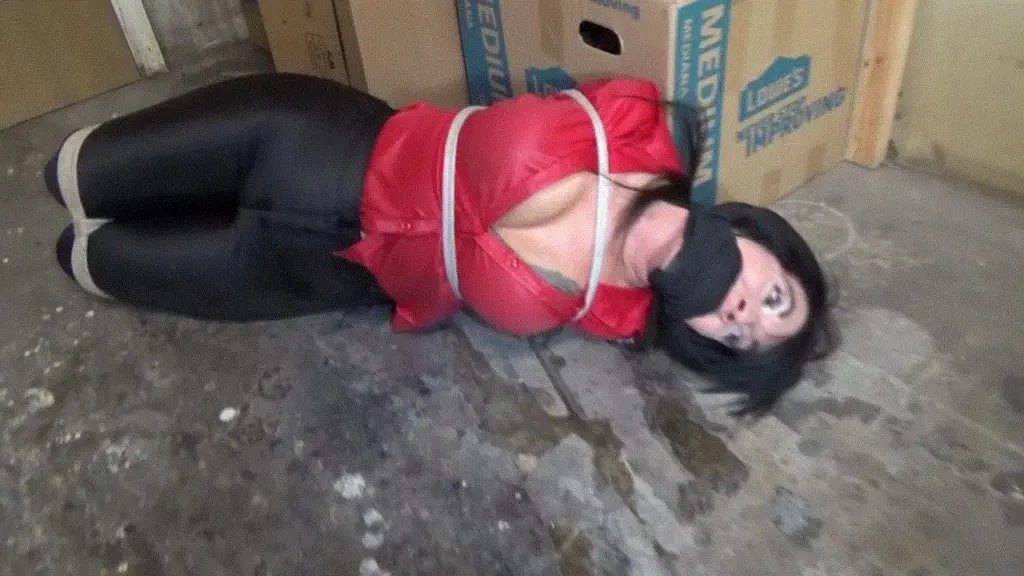 THIEVING WAREHOUSE MANAGER LEFT TIGHTLY HOGTIED MP4 I have been waiting all day for the last one of my employee's, Nyxon, to leave for lunch. We have made a few big sales today and I needed to take my skim before they tally the figures after lunch. I bid Nyxon goodbye then as soon as she is gone I go for the cash. But the dumb broad must have forgotten something as I am surprised by the door opening and Nyxon walking back in. I quickly stuff the cash into the waist band of my skin tight disco jeans and studder an excuse when she accuses me of stealing. I try to get the upper hand but I am caught red handed, maybe if I let her search me she just might miss the wad of cash in my waist band. I allow Nyxon to search me by standing with my hands behind my head as she pats me down. She finds the cash and I am caught, I try to beg and plead with her not to call the cops. Then she gets this sick twisted grin on her face and tells me that she has had a secret fetish and has been fantasing about tying me up. I reluctantly consent to her tying me up, I don't want to go to jail, beside how bad could it be? Just a few ropes and I am off scot free. She ties my legs tightly together, I am impressed by her skills. Then she pulls my elbows together behind by back and wraps her ropes around my upper arms and cinches my elbows tighthly together. I am now having second thoughts about this, but it is too late, I am helpless to stop her. I protest but my protests are answered by a huge rag stuffed into my mouth. With my poor jaws spread wide by the rag she then wraps black elastic bandage tightly over my mouth and around my head gagging me to silence. She then ties my wrists tightly together before laying me down on the floor. Nyxon ties the rope around my elbows down to my bound ankles and pulls the rope taut until my ankles are pulled up to my hands in a cruel hogtie. She then tauts and teases me, Nyxon stuffs the cash into her bra and tells me that she is now going to lunch and maybe do a little shopping at my expense. But not to worry because the other employees should be back soon and maybe they my untie her. But maybe not since I am such a haughty bitch to work for they just may leave me tightly bound, gagged and hogtied for the day. I watch as she leaves me helpless but I am already plotting my revenge.<br><br>