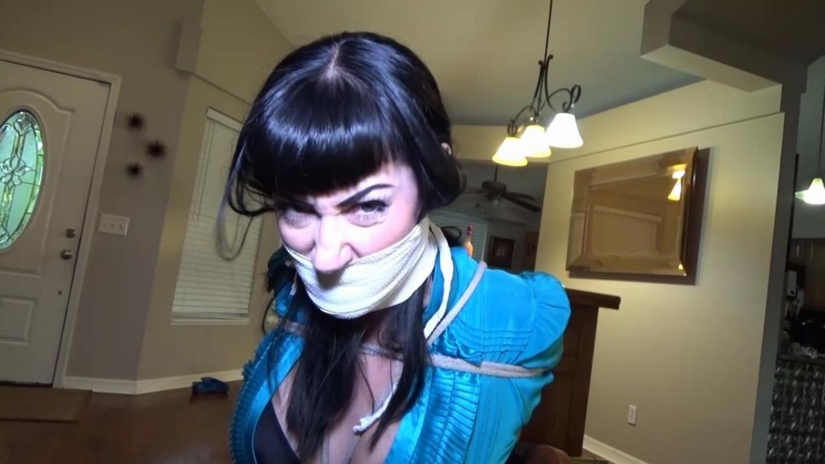 SNOOTY BANKER BOUND &amp; GAGGED MP4 Fiona Sinclair is so excited.  Today is the day the banker comes and she signs for her loan for her new business.  The grand opening is this weekend and Fiona is just overjoyed about this new venture.  The banker Nyxon arrives with a snooty attitude and informs Fiona that her loan has been denied.  Fiona cannot believe the nerve of her bank and of the haughty bitch banker as she sits there completely stoic delivering the bad new.  Infuriated by this, Fiona grabs a wet cloth and presses it over the banker's face.  Nyxon struggles but the fumes are strong and soon she is .  She wakes up completely tied down in a chair - her elbows painfully crushed together.  Furious Fiona is standing over her demanding that her loan be approved.  Nyxon tells Fiona this is not happening and threatens to call the police if Fiona doesn't calm down.  Fiona laughs out loud as she stuffs Nyxon's mouth with a rag.  She wraps Nyxon's beautiful face with lots of layers of vet wrap until the banker is silenced to grunts and groans.  Fiona is having a blast taunting and tormenting the uppity banker.  She gropes Nyxon's big tits and sits on her lap.  She gives Nyxon a lap dance mocking her then she tilts the chair backward making the bound banker scream in fear through her gag.  Nyxon still refuses to adjust the numbers on Fiona's loan and this infuriates Fiona.  She grabs the banking documents, plants herself on Nyxon's lap and adjusts the figures herself doubling the amount and lowering the interest.  Finally satisfied with the new loan numbers she shoves the paperwork in Nyxon's bound hands and her to sign.  Fiona goes off to the bank to collect her money leaving the uptight banker helplessly bound and gagged.<br><br>