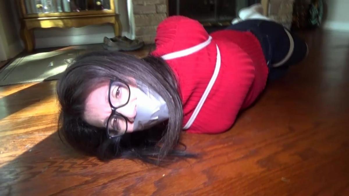 TIED UP IN A TURTLENECK, SKIN TIGHT JEANS &amp; SLOUCHY SOCKS MP4 I'm tightly tied in my turtleneck sweater, skin tight jeans and slouchy socks.  Lots of rope is on my body.  Elbows crushed together, wrists, ankles, knees and a chest harness accentuating my tits. A little way into the video I am gagged with a lot of stuffing and tape gagged with strips of duct tape.  At the start the video I am mad about being bound so tightly and I protest through the gag angrily mmmmphhhing and groaning.  I struggle furiously rolling around the carpet.  After several long minutes I begin to get turned on by the feeling of helplessness.  My pussy gets wet and I'm enjoying the tight bondage so much.  My grunts and angry groans turn to moans of pleasure as I roll around the rug getting off on being unable to escape. <br><br>