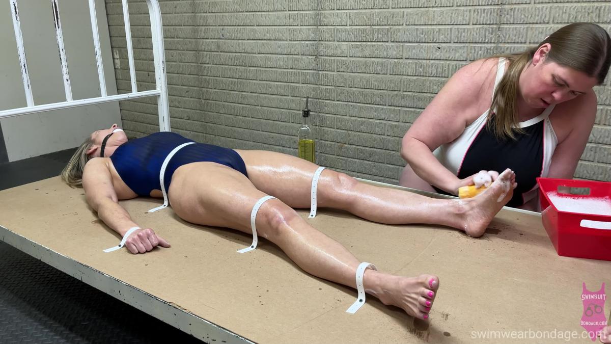 378 Clair foot cleaning Clair Irons is wearing a tight fitting speedo aquablade one piece swimsuit and is strapped down and ball gagged by Jess Jordan. Jess decides Clair's feet are extremely dirty and decided to clean them very well.  