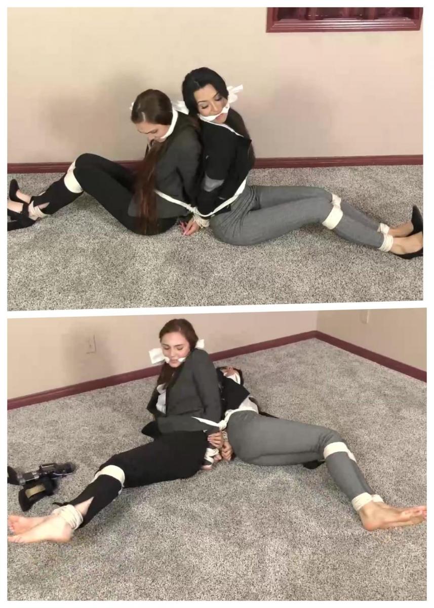 QT0984 Kristen Moore &amp; Michelle Jennings (is-qt-km-mijen002) 克里斯汀·摩尔（Kristen Moore）和米歇尔·詹宁斯（Michelle Jennings）是两名侦探，他们被指派追踪并逮捕该市最大的犯罪头目之一。但这两名漂亮的侦探被抓了，最后被绑住了。现在他们被召集到专员办公室，在那里他们必须解释他们的错误。有趣的是，他们对事情是如何发生的以及该怪谁有不同的记忆！这个富有创意的多视角故事线有我们的两名侦探，每个人都试图向老板解释这个故事，让她看起来更负责任，但我们真正注意到的是两名美女，穿着职业休闲裤和夹克，还有很多绳子！Kristen Moore & Michelle Jennings are 2 detectives who were given the assignment of tracking down & arresting one of the city’s biggest crime bosses. But the 2 beautiful detectives got captured and ended up bound & gagged. Now they have been called into the commissioner’s office where they have to explain their screw up. Interestingly, they have different memories of how things happened and who is to blame! This creative, multi-perspective storyline has our 2 detectives each trying to explain the story to the boss in a way that she looks like the more responsible partner, but all we really notice is 2 beautiful women, dressed in professional slacks & jackets, and lots of rope!<br>