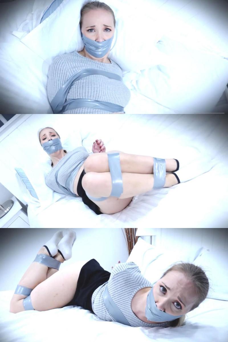 Lil Missy UK - Livestream Interrupted Bondage Video HD Missy is online, live-streaming, but someone wants to see something different! One of her online fans interrupts her streaming session. Streamer Missy, in jumper, skirt and ankle-socks, is surprised and soon finds herself securely taped up, with arms behind her, wrists bound together, tape above and below her breasts also pinning her arms, and legs restrained in three places. Mouth stuffed, a wraparound duct tape gag quietens her protests. Missy struggles on her bed, mmpphh-ing and pleading with her eyes.Missy在线直播，但有人想看到不同的东西！她的一位在线粉丝打断了她的流媒体会话。穿着套衫、裙子和踝袜的Streamer Missy很惊讶，很快发现自己被牢牢地绑住了，手臂在身后，手腕绑在一起，胸部上方和下方的胶带也将她的手臂和腿固定在三个地方。嘴里塞满了东西，一个缠绕的管道胶带插科打诨平息了她的抗议。米西挣扎在床上，用眼睛哀求。