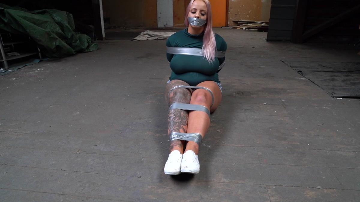 1089 Tenacious in Turtleneck Taped on the dirty floor Tenacious is wearing shorts and a tight turtleneck sweater. She gets taped