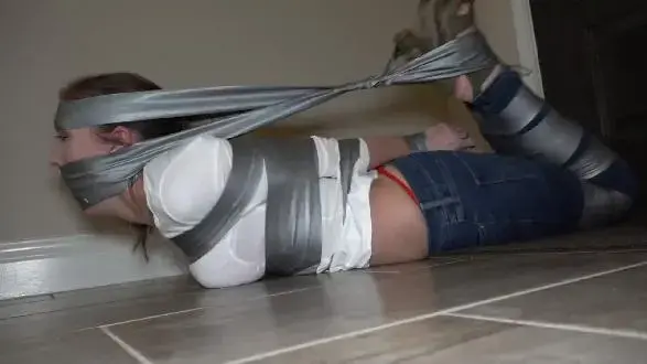 2303NRACHEL-Hog-taped and gagged on the floor At first he has her taped up and gagged in the bathroom. But when she tries to escape he hog-tapes her. NOTE: I added a short Behind the scenes segment at the end of this video<br><br>