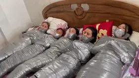 Trapped In Mummy Mansion: 5 Mummified Girls Struggle All Wrapped Up And Gagged! (high res mp4) In the heart of South America, a grand mansion conceals a dark and captivating secret. Five young women, each with their own unique personalities and backgrounds, find themselves mysteriously trapped within its walls.<br><br>The ladies are barefoot and stuck in entangling duct tape mummification on a bed and their mouths are stuffed and tape wrap gagged tight.