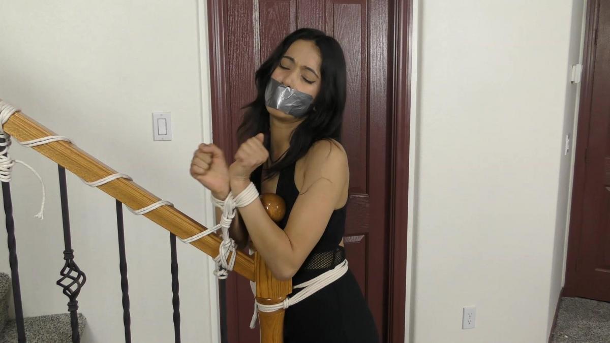 QT0997 Bethany Fontaine (is-qt-bf033) Bethany Fontaine is a porch pirate who has been plaguing a neighborhood with her thieving ways. Today, she steals from the wrong house and gets caught in a net trap! Wearing a long black dress with her hands tied in front, she is pulled into the house and tied to the banister. She protests, but is silenced with stuffing & tape. The homeowners tell her they are inviting all her victims over for a house party where she will be the guest of honor which sends the beautiful criminal into a panic!