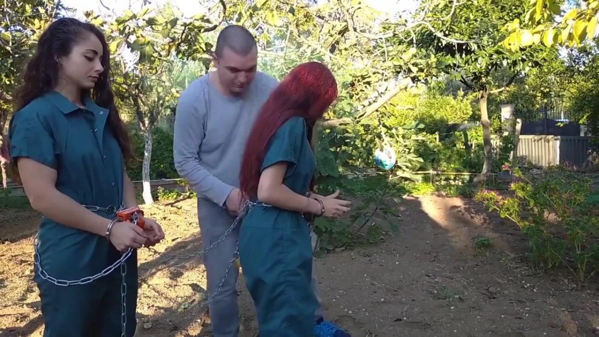 Walking to jail works Meelina and Laura are two dangerous inmates.<br>Meelina is already handcuffed in maximum security restraints: waist chains maximum security handcuffs and black box and legirons.<br>Laura is handcuffed by a guard also in maximum security mode.
