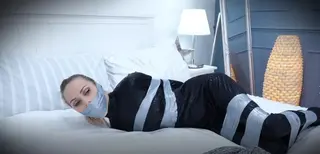 Chloe - Catsuit Burglar Mysterious Bondage wrap gag eautiful burglar Chloe takes a rest, but ends up restrained!<br> <br>Catsuited, pony-tailed and stocking-footed burglar Chloe decides on a short snooze after a hard day's 'work', but while she rests, the ravishing robber is taped up, arms behind, tape above and below her breasts, legs secured with many wraps around her thighs, calves and ankles. She doesn't seem too perturbed, and remarks that at least she hasn't been gagged. Yet. <br><br>Next thing she knows a tape-gag has been wrapped around her head, quietening Chloe considerably. She writhes about on the bed, and is a little less happy now, finding that she is completely unable to break free from her bonds.<br> <br>Gag 1<br>An unseen hand then replaces her gag: a large green ball is held in place by a clear tape-gag. Chloe's struggles become more urgent, but no more successful. As she moves about the bed, her delightful bottom is showcased, and she flashes her lovely eyes at the camera (and us).<br>Layer 1<br>Next, a tight Microfoam wrap around tape-gag is applied, wrapped right around, to further silence the lovely thief, Chloe struggles hard to get out of 